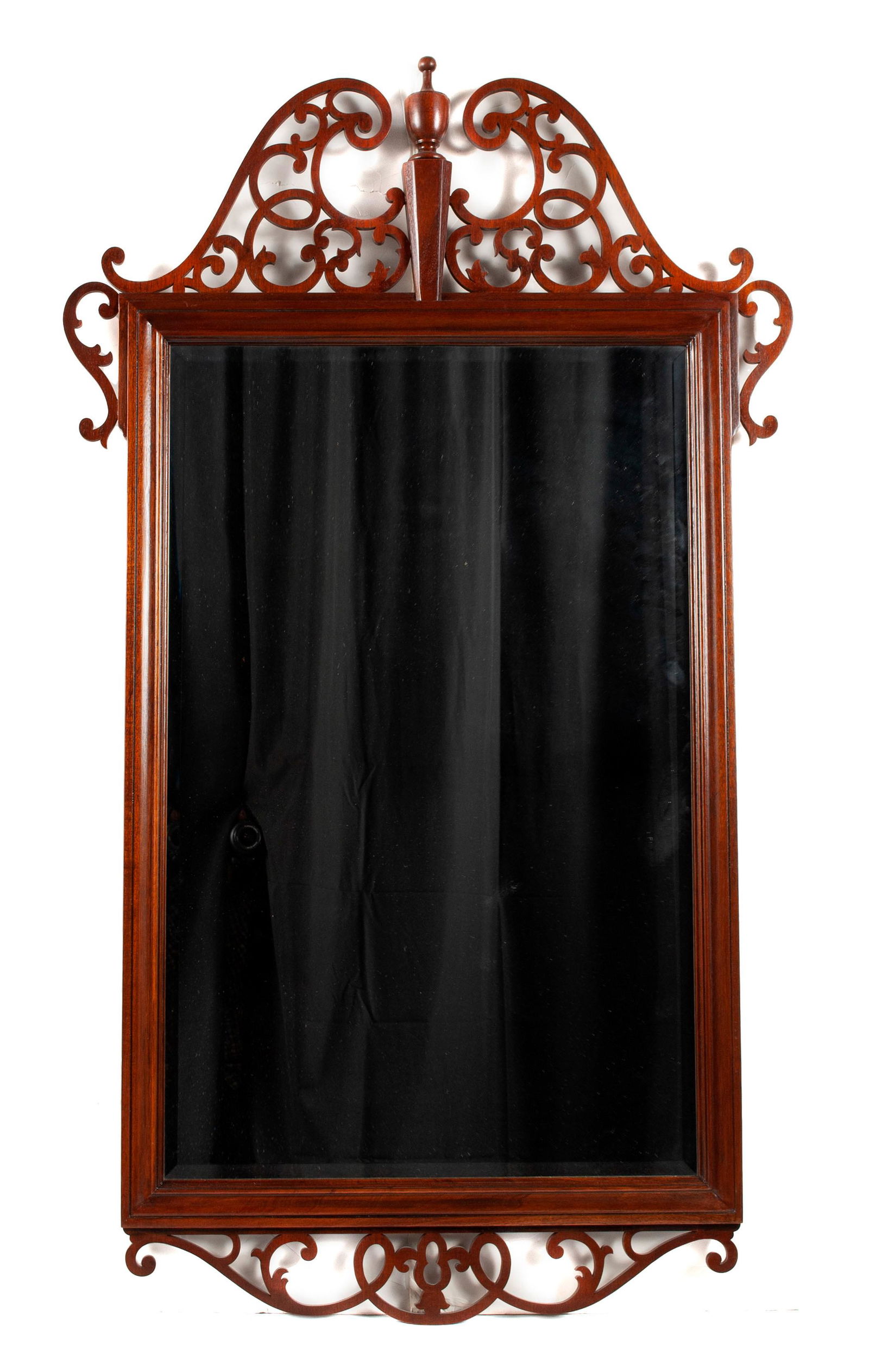 OPEN FRETWORK WALL MIRROR BY BAKER: OPEN FRETWORK WALL MIRROR BY BAKERScrolling, intricate openwork crest encircling the upper corners of the beveled frame, more scrollwork below.53 x 31 in. (134.62 x 78.74 cm.)