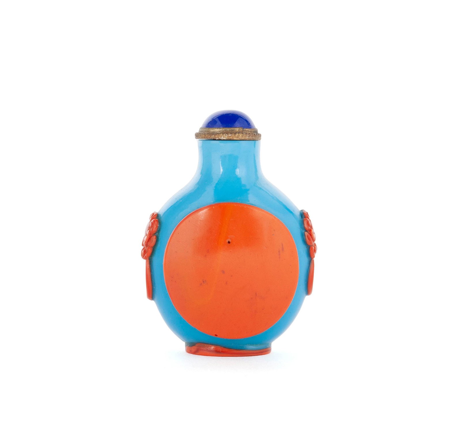 AN ORANGE OVERLAY TEAL GLASS SNUFF BOTTLE: AN ORANGE OVERLAY TEAL GLASS SNUFF BOTTLE Chinese, early 20th century, glass. Orange circle overlaid to bright blue bottle and shoulders of well carved ringed lion masks, matching orange foot rim. Bot
