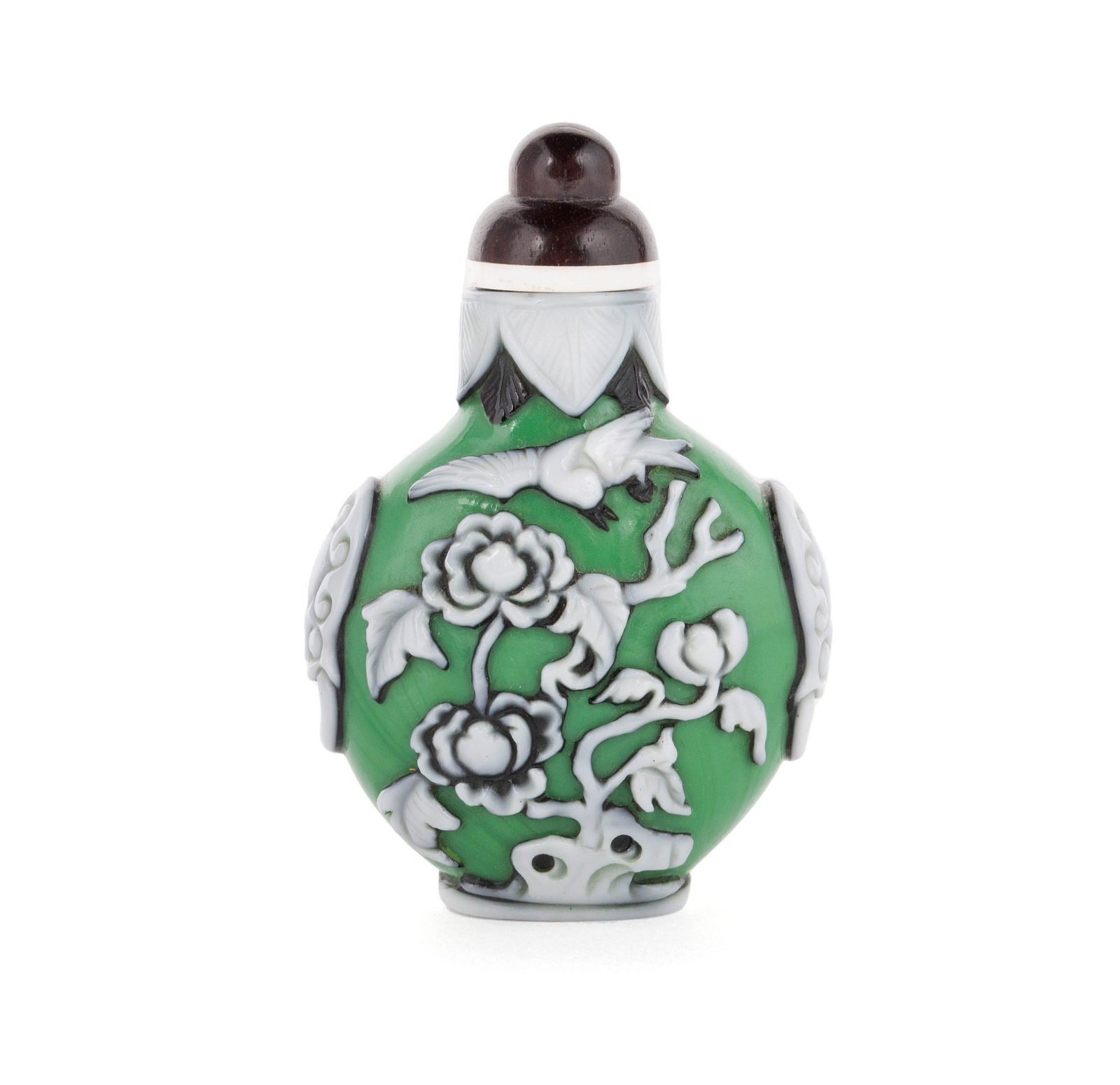A WHITE AND BLACK OVERLAY GREEN GLASS SPIDER SNUFF BOTTLE: A WHITE AND BLACK OVERLAY GREEN GLASS SPIDER SNUFF BOTTLE Chinese, mid-20th century, glass. An unusual bottle having a spider and web amongst bamboo and a magpie flying over peonies, white ring masks 
