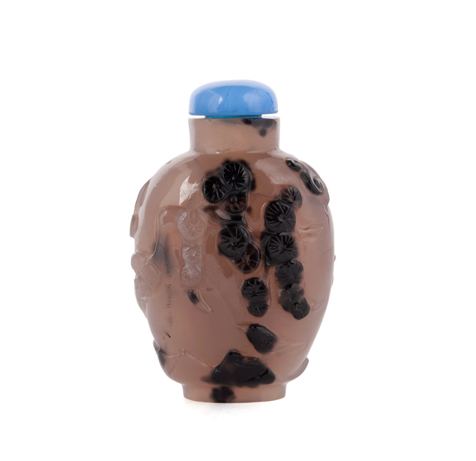 A MASTER OF THE ROCKS SCHOOL SHADOW CHALCEDONY SNUFF BOTTLE: A MASTER OF THE ROCKS SCHOOL SHADOW CHALCEDONY SNUFF BOTTLEChinese, 19th century. Russet carved skin to a magpie and pine tree-carved stone bottle, raised on recessed oval foot rim.Bottle: 2 1/4 in. (