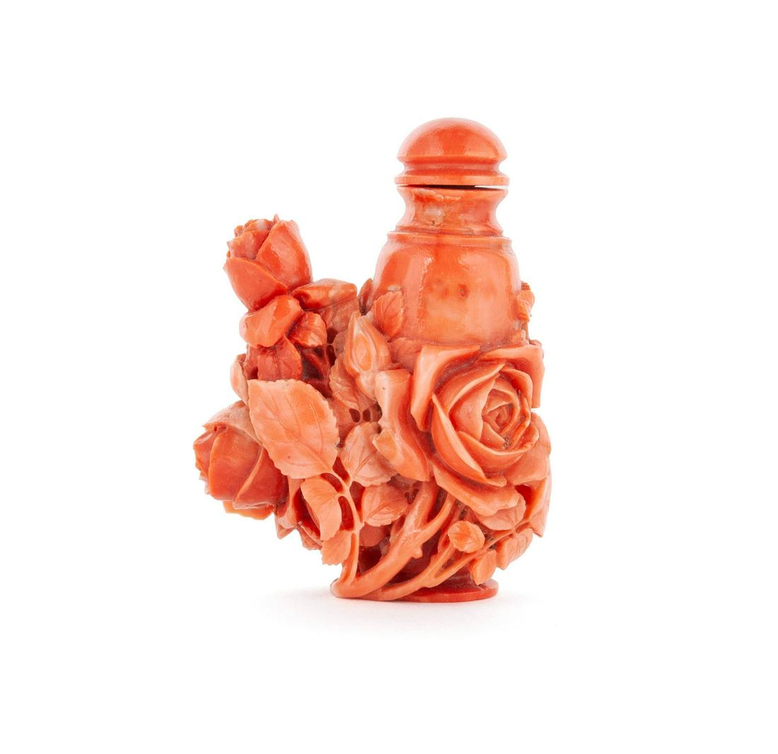 A FINELY CARVED FLORAL SNUFF BOTTLE: A FINELY CARVED FLORAL SNUFF BOTTLE Chinese, 19th-early 20th century. Heavily carved in relief with roses and asters, the underside with concave, ringed footing. Bottle: 2 1/8 in. (5.40 cm.), with sto