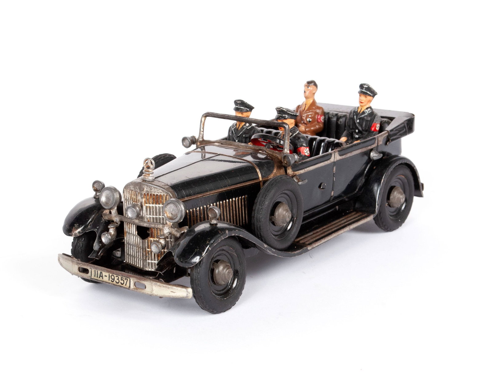 TIPPCO CLOCKWORK MERCEDES MILITARY STAFF CAR WITH FIGURES INCLUDING HITLER: TIPPCO CLOCKWORK MERCEDES MILITARY STAFF CAR WITH FIGURES INCLUDING HITLER German, c. 1940, tin and composition. Black vehicle with "11A-19357" to front and back bumpers, with four compositi