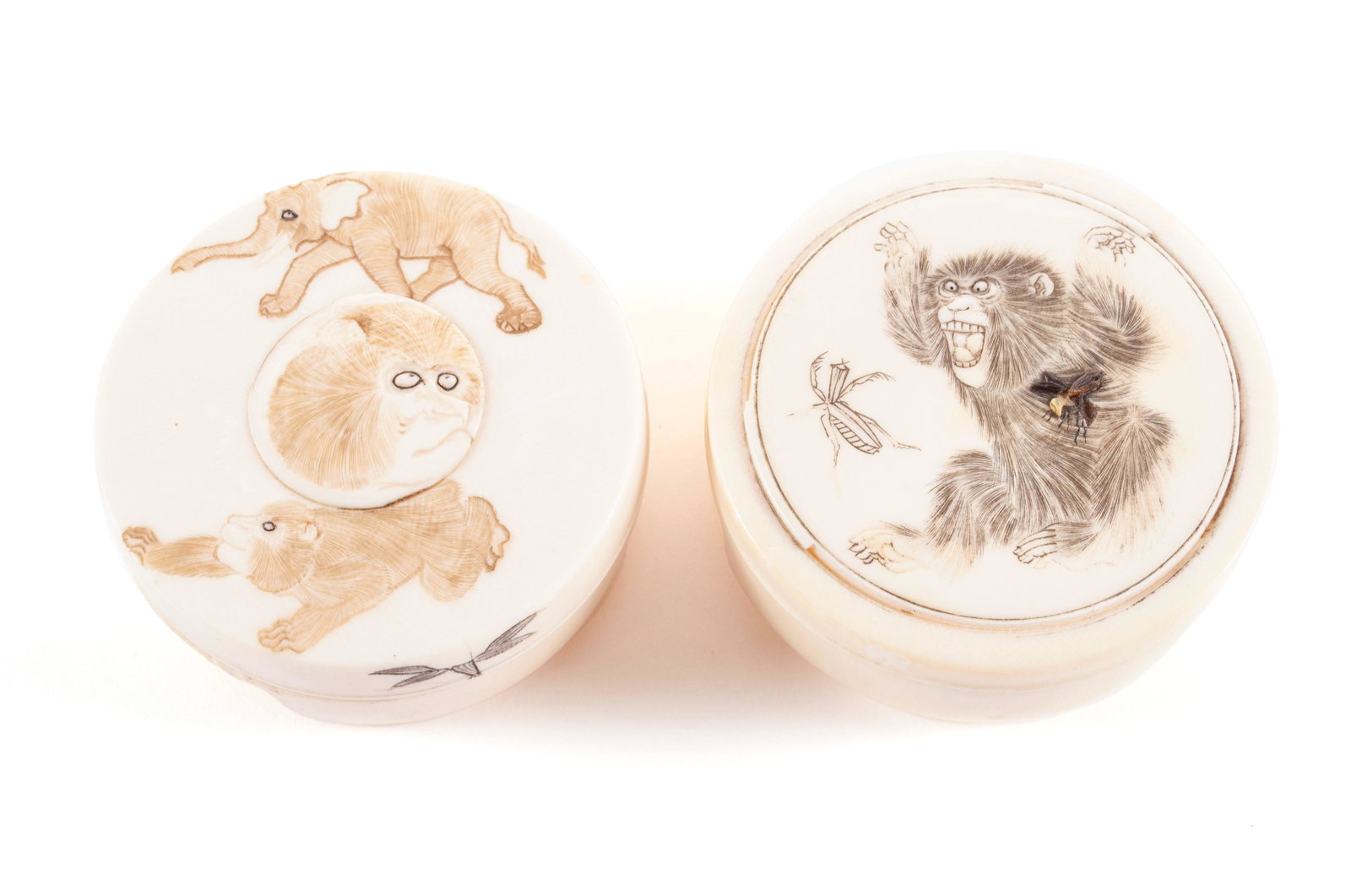 TWO MEIJI ERA CARVED MONKEY BOXES: TWO MEIJI ERA CARVED MONKEY BOXES Japanese, late 19th-early 20th century, organic material. One with monkey playing with shibiyama inset insects and the other featuring monkeys and an elephant. Both a