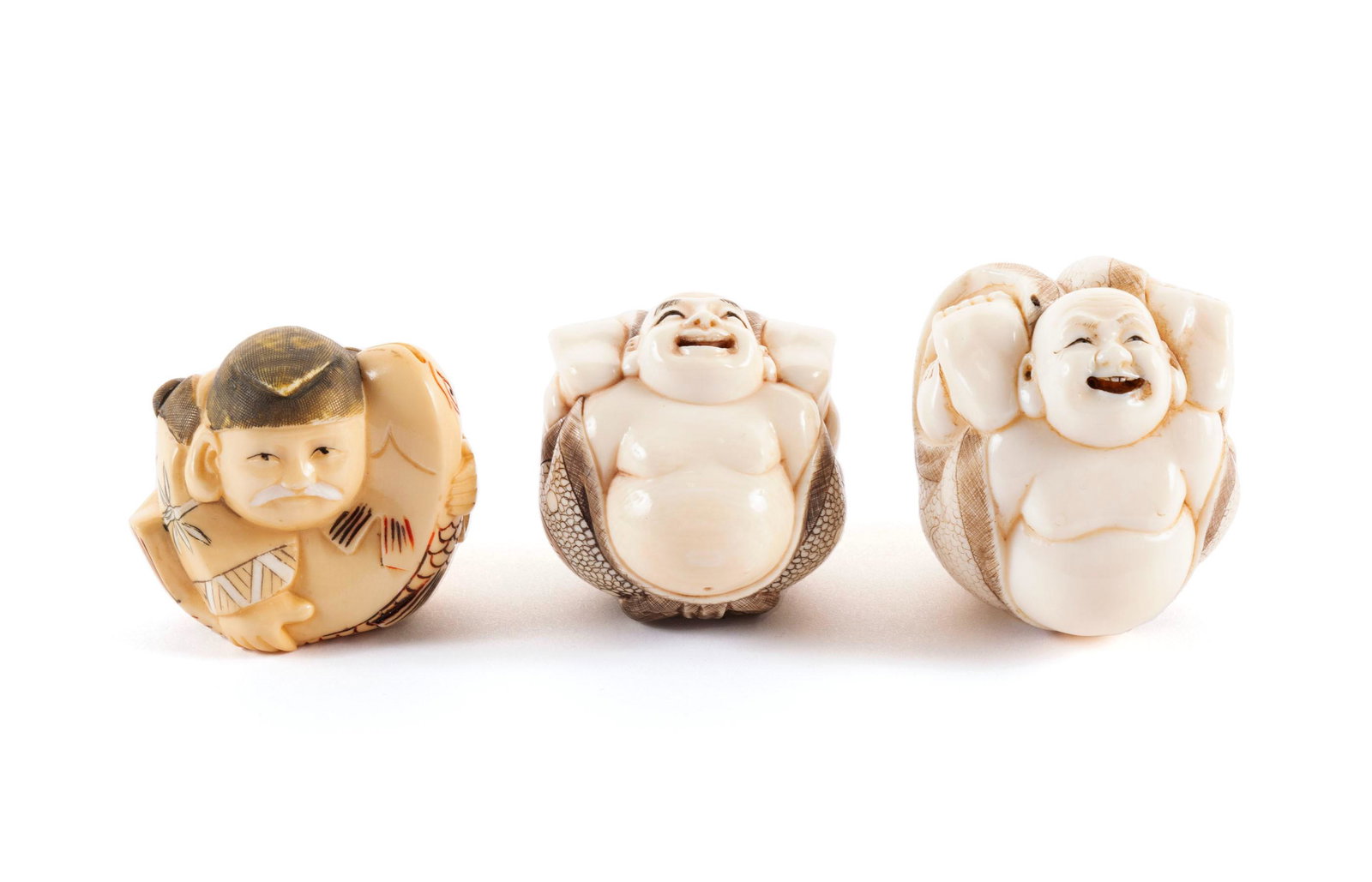 THREE BALL FORM FIGURAL NETSUKE: THREE BALL FORM FIGURAL NETSUKE Japanese, early 20th century, organic material. Two true ball form Hotei/laughing Buddha, and one of a figure holding fish. All signed. Largest: 1 3/4 in. (4.4 cm.)
