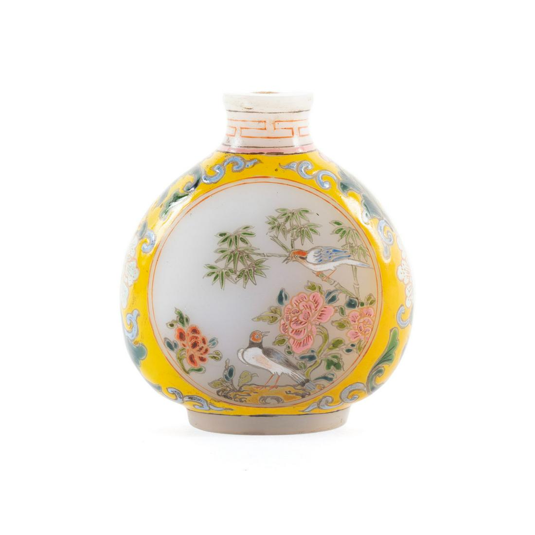 ENAMELED GLASS SNUFF BOTTLE: ENAMELED GLASS SNUFF BOTTLE Chinese, early 20th century, enameled glass. Famille rose style paintings of birds amongst foliage to either side of the yellow-grounded bottle; a three-character mark to t