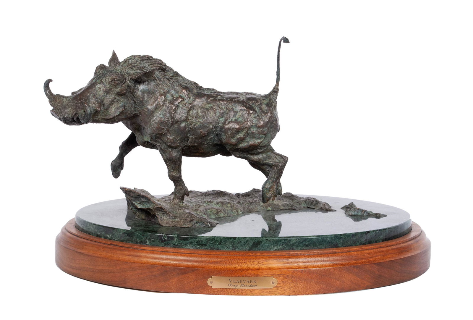 GREG BEECHAM (AMERICAN, B. 1954): Greg BeechamAmerican, b. 1954VlakvarkBronze, signed, edition 4/30Trotting warthog/boar with raised tail, mounted to a revolving stone and wooden base with brass plaque.Bronze: 8 1/2 x 16 in. (21.6 x