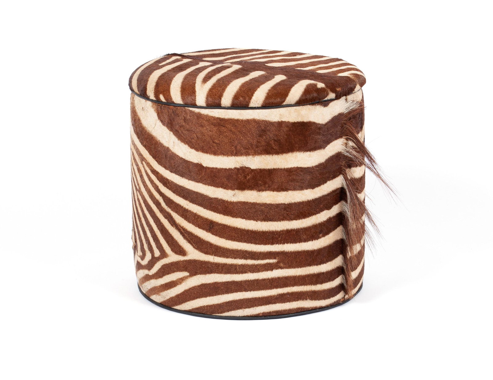 ZEBRA SKIN HASSOCK: ZEBRA SKIN HASSOCK Mid-20th century. The ottoman with round top and cylindrical body covered in a fine zebra skin with mane. 17 3/4 x 18 in. (45.1 x 45.7 cm.) The Wallace Estate: Lee Renfrew Wallace a