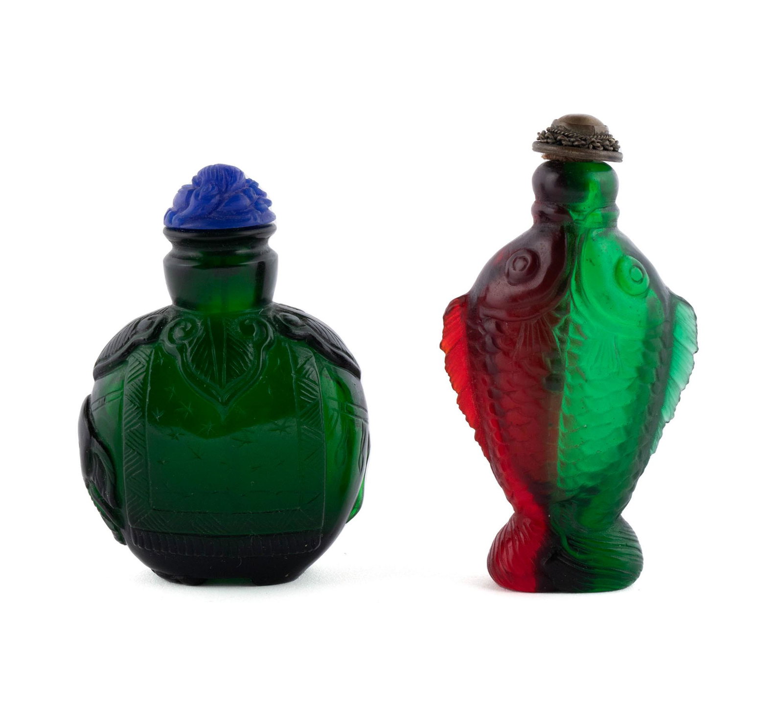 TWO GREEN GLASS ANIMAL FORM SNUFF BOTTLES: TWO GREEN GLASS ANIMAL FORM SNUFF BOTTLES Chinese, mid-20th century, glass. A dual green and red fish form snuff bottle along with an elephant form in dark green, with cobalt colored stopper. Taller b