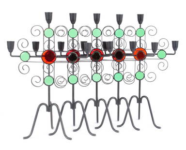 FIVE GUNNAR ANDER FOR YSTAD CANDELABRA: FIVE GUNNAR ANDER FOR YSTAD CANDELABRASwedish, 1960s, iron and glass. Five (5) three-light candelabra, each inset with green and red glass accents in cross form.15 3/4 in. (40 cm.)