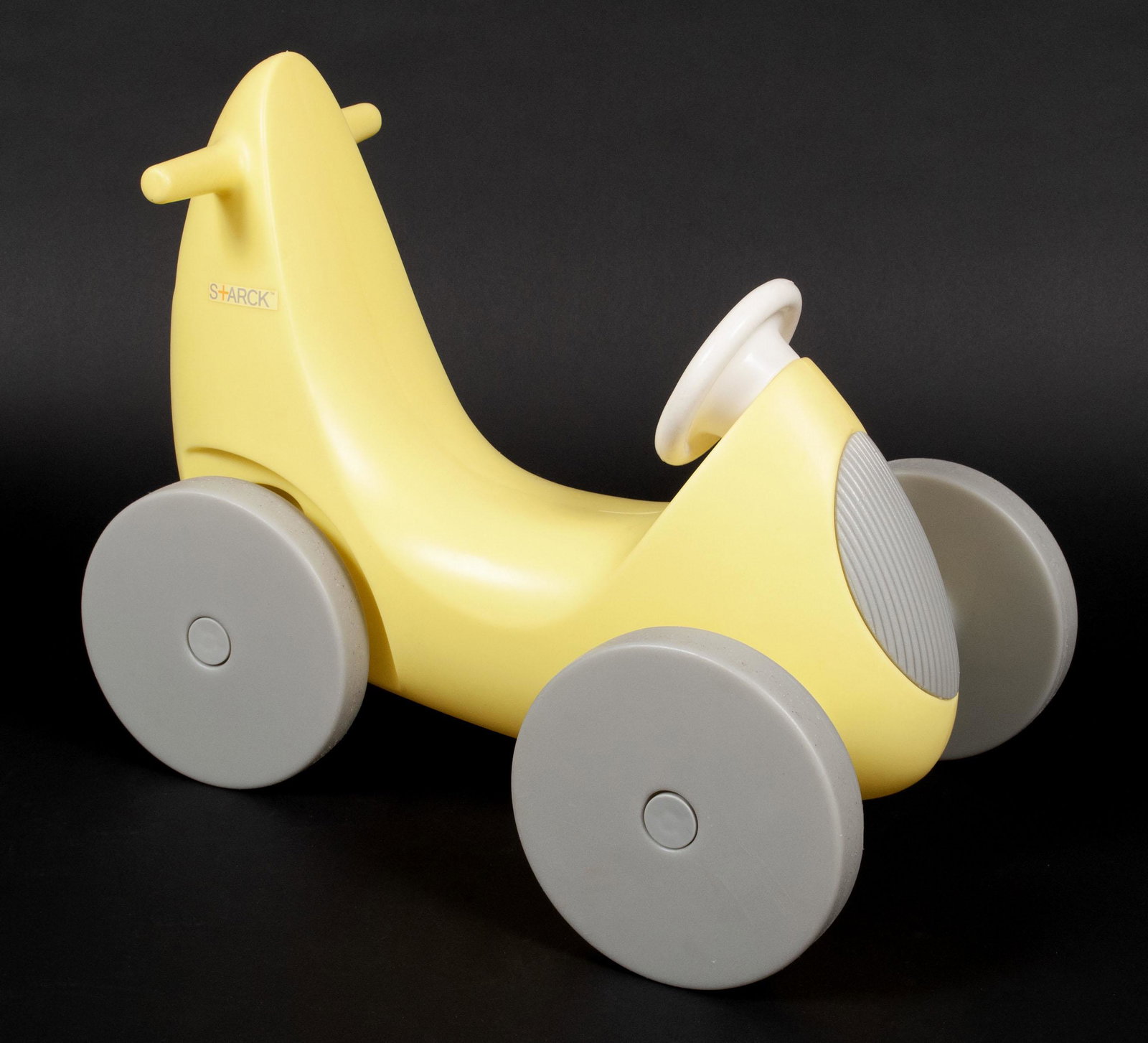 PHILIPPE STARCK TOY PUSH CAR: PHILIPPE STARCK TOY PUSH CARFrench design, early 21st century, hard plastic. Designed by Philippe Starck, in yellow with the S+arck labeling to the side.19 1/2 x 17 x 23 1/2 in. (49.5 x 43.2 x 59.7 cm