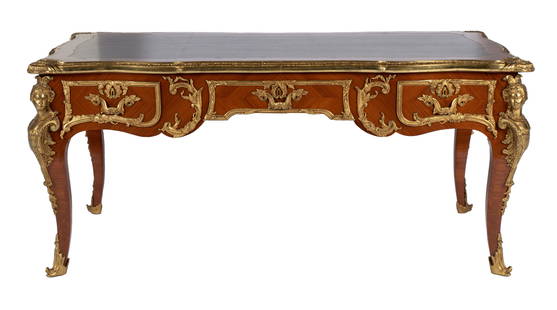 LOUIS XV STYLE BUREAU PLAT: LOUIS XV STYLE BUREAU PLATContinental, 20th century, in the 18th century style of Charles Cressent. Elaborate ormolu mounts allover, the top with parquetry crossbanding around the tooled leather inset
