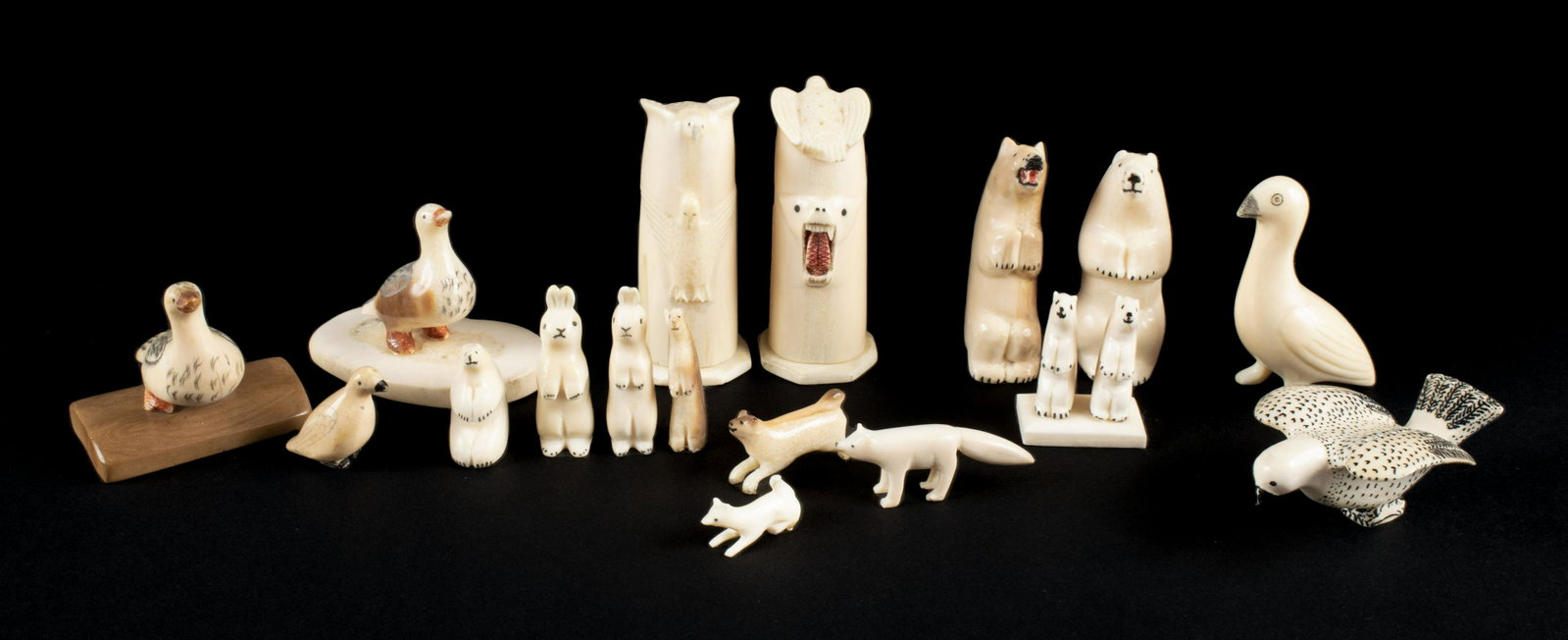 SELECTION OF INUIT CARVED DIMINUTIVES: SELECTION OF INUIT CARVED DIMINUTIVES Alaskan (Reindeer People), c. 1900, organic material. Seventeen (17) total terrestrial carvings with scrimshaw and pigment decoration, including two mounted ducks