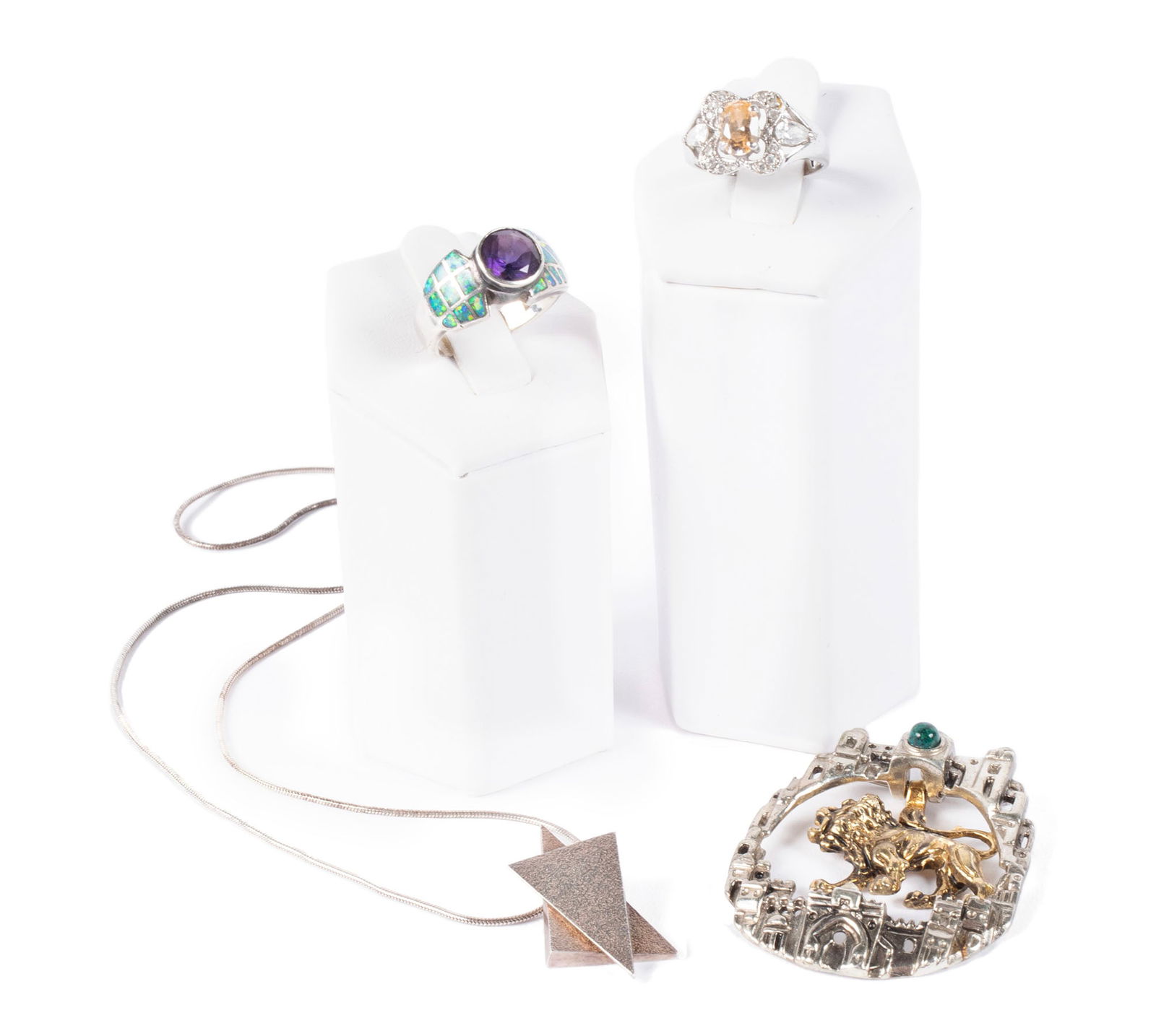 COLLECTION OF STERLING JEWELRY: COLLECTION OF STERLING JEWELRYA sterling "Leo" zodiac pendant brooch by Frank Meisler, an abstract pendant on necklace chain, a costume ring, size 5.5, and a ring by David R. Freeland Design