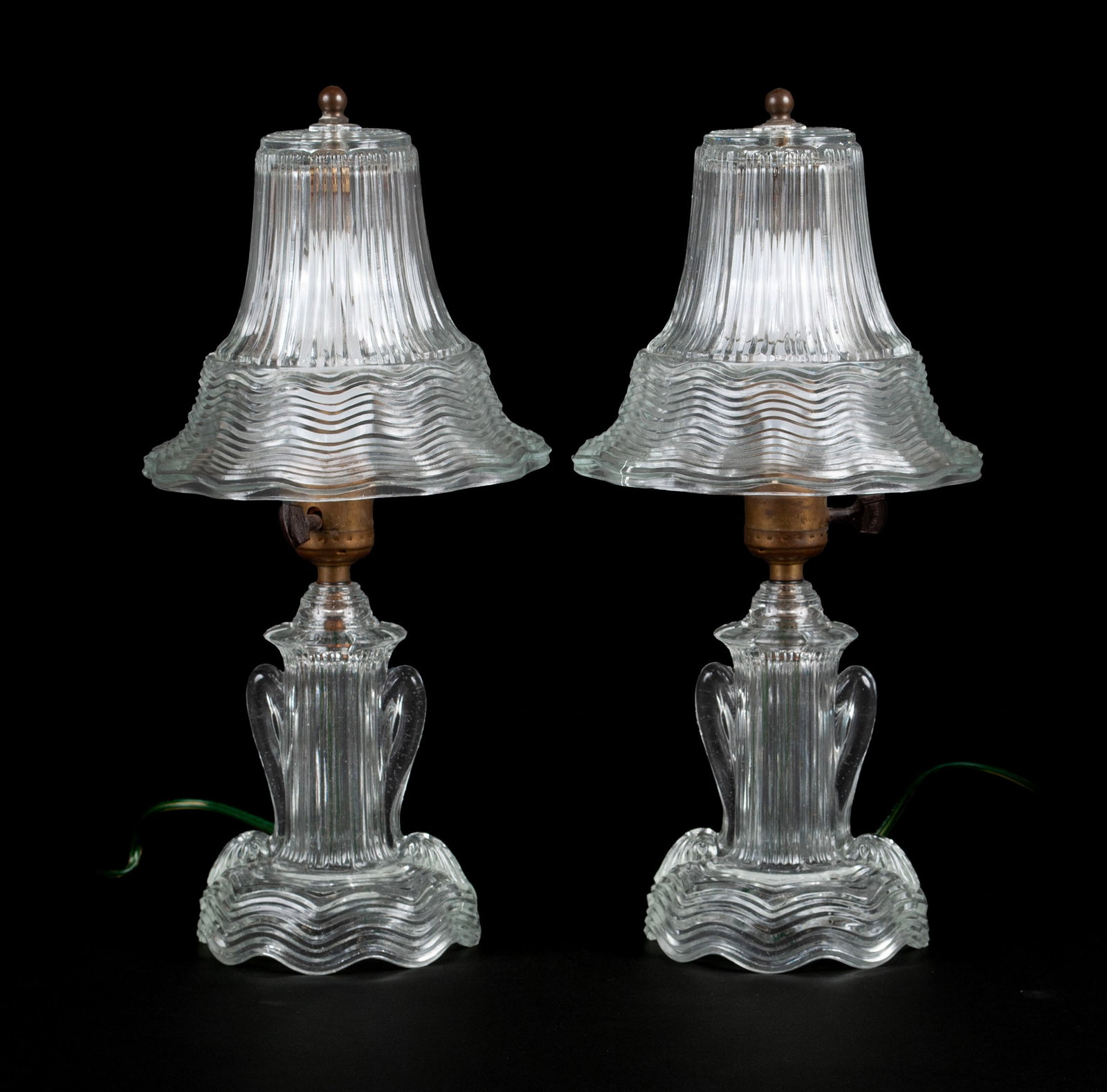 PAIR OF ART DECO FLUTED GLASS BOUDOIR LAMPS: PAIR OF ART DECO FLUTED GLASS BOUDOIR LAMPS American, second quarter 20th century. Ribbed shades and standards of translucent cast glass, unmarked. Each 14 1/2 in. (36.8 cm.)