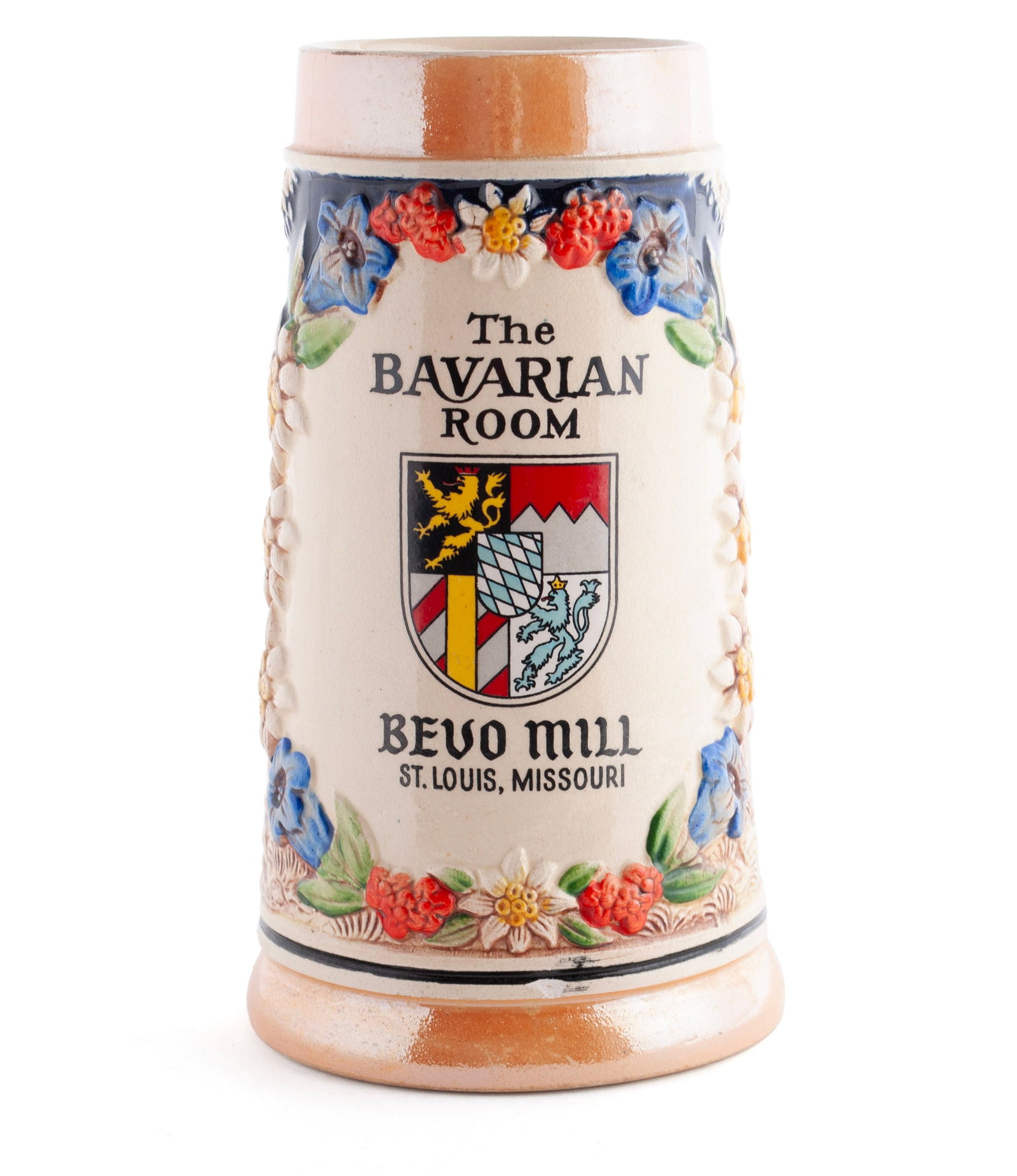 THE BAVARIAN ROOM: BEVO MILL BEER MUG: THE BAVARIAN ROOM: BEVO MILL BEER MUG Western German, circa 1950s, stoneware. A half liter mug with figural and foliate decoration flanking the above inscription. 7.1 in. (18 cm.) Bevo Mill, St. Louis