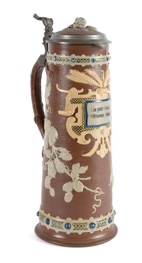 METTLACH STONEWARE TWO LITER STEIN #1737: METTLACH STONEWARE TWO LITER STEIN #1737 German, impressed marks underfoot. Decorated with hops and the text ?Ein guter Grund will keinen Schund (Good ground does not want rubbish)" on a dark bro