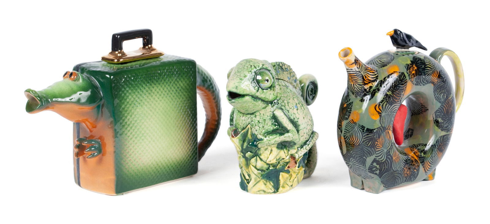 TRIO OF FIGURAL TEAPOTS: TRIO OF FIGURAL TEAPOTSThree (3) art pottery teapots: "Alligator Suitcase" by John Groth, 1992; a circular form with bird finial and foliate design by Kris Cravens; and a chameleon by Andy T