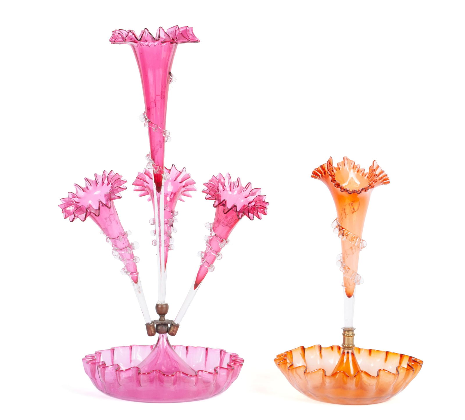 PAIRING OF VICTORIAN EPERGNES: PAIRING OF VICTORIAN EPERGNESAmerican, 19th century, glass. an amber single-lily epergne and a cranberry epergne with rigaree ornamentation.21 x 9 1/2 in. (53.3 x 24.1 cm.), & 14 x 8 1/2 in. (35.6 x 2