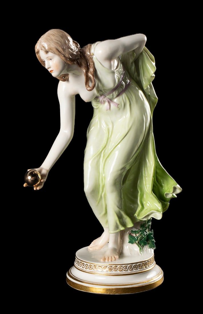 MEISSEN FIGURINE BY WALTER SCHOTT: MEISSEN FIGURINE BY WALTER SCHOTTGerman, 19th/20th century. Young lady ready to throw a golden ball underhanded.11.6 in. (29.5 cm.)