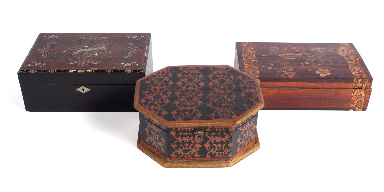 THREE DECORATIVE BOXES: THREE DECORATIVE BOXES19th/20th century. Three (3) decorative boxes, including one (1) hexagon shaped lidded box with flowers and scrolls painted red and gold against a black background to all sides a