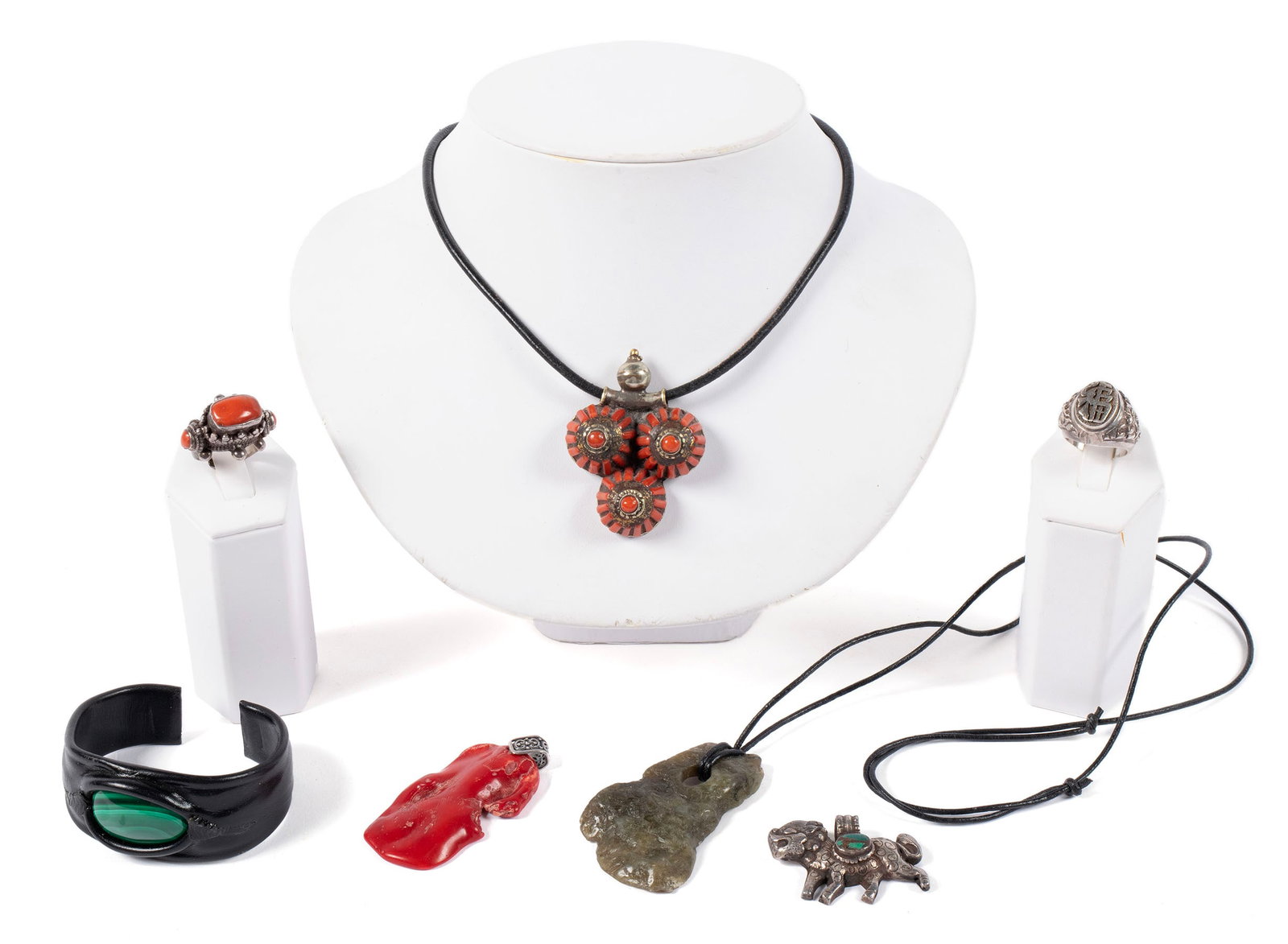 MISCELLANEOUS JEWELRY: MISCELLANEOUS JEWELRY Seven (7) pieces including a Tibetan sterling and coral ring marked 925 (Size 8); a silver and coral pendant on a corded necklace; an unmarked silver Tibetan show lion pendant, i