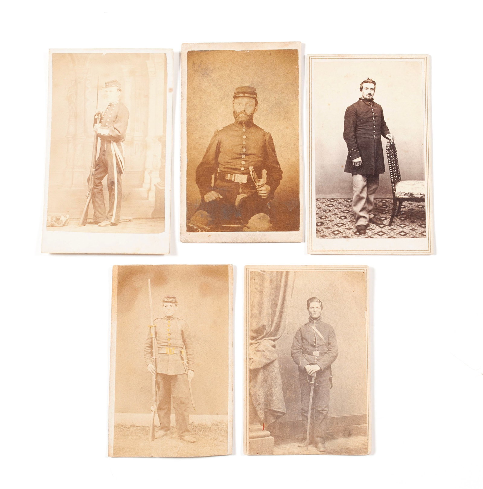FIVE U.S. MILITARY CARTE DE VISITE: FIVE U.S. MILITARY CARTE DE VISITE American, 19th century. Five (5) unidentified Union soldier Cdv's, standing soldier with rifle with bayonet, pencil inscription to verso " compliments of your c
