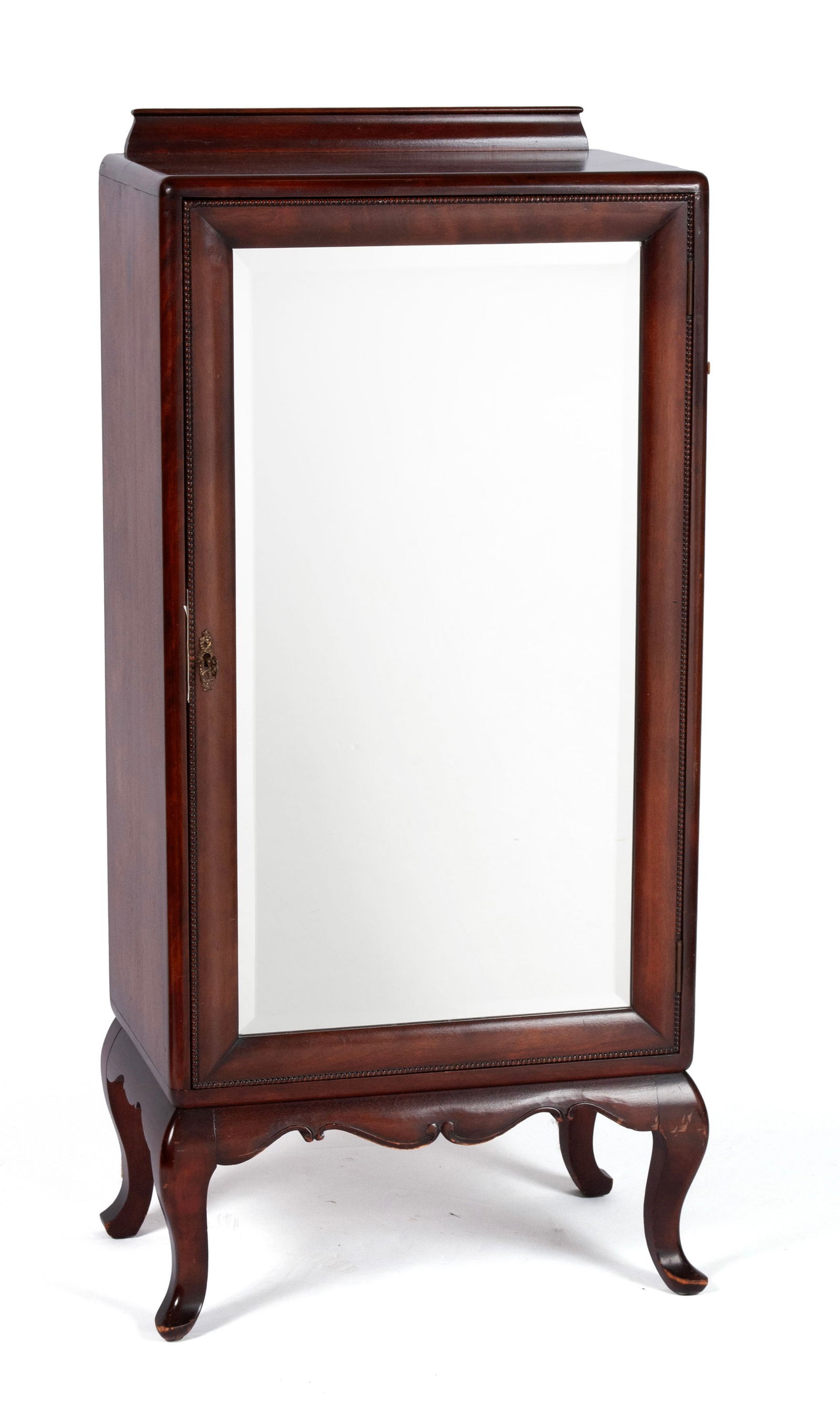 MAHOGANY MUSIC CABINET: MAHOGANY MUSIC CABINETAmerican, mid-20th century. Full length mirrored door covers the shelved interior with shaped apron and cabriole legs.46 x 21 x 13 in. (116.8 x 53.3 x 33 cm.)