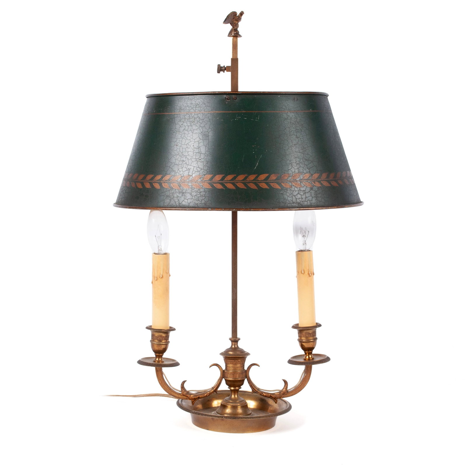 BRASS BOUILLOTTE LAMP: BRASS BOUILLOTTE LAMP 20th century. Eagle finial over a green tole shade and two scrolled candle arms, on a dish base. 22 x 13 in. (55.9 x 33 cm.)