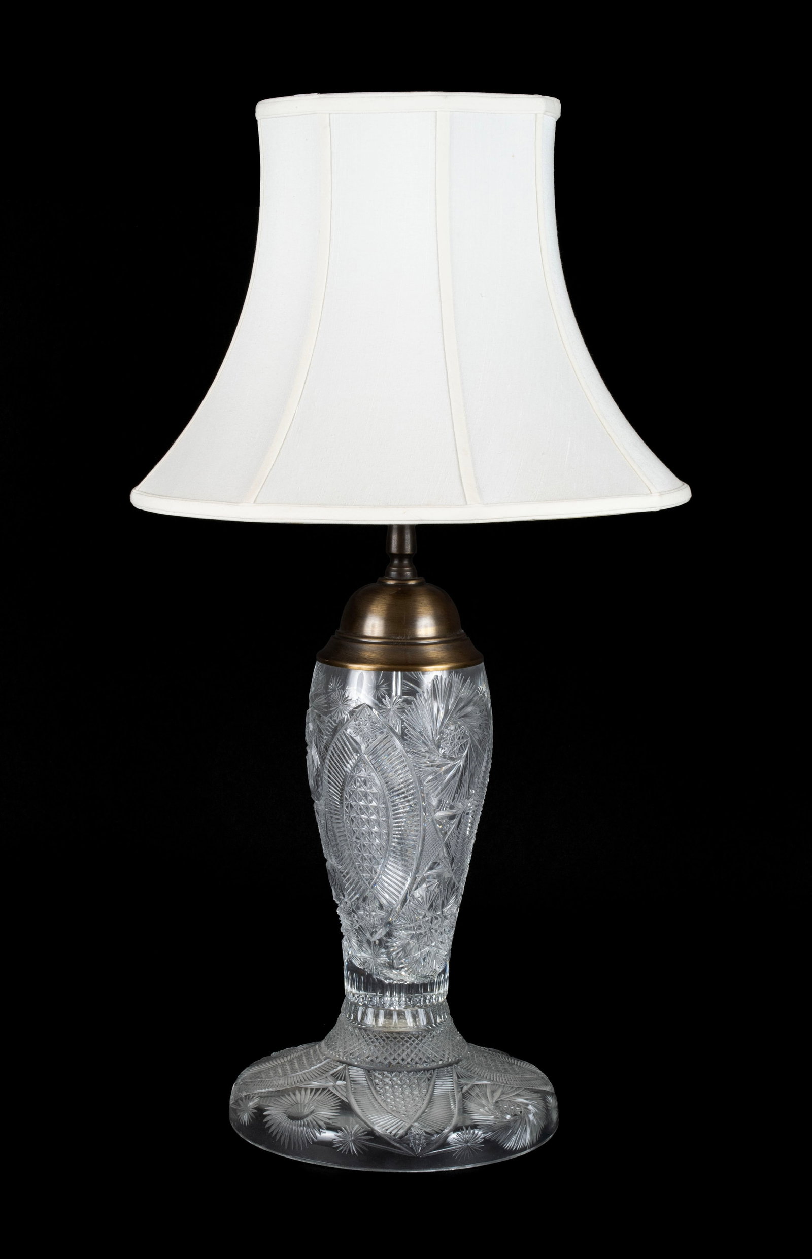 CUT GLASS LAMP: CUT GLASS LAMP 20th century. With diamond and sunburst designs on a slightly domed foot. 30 1/2 x 10 in. (77.5 x 25.4 cm.)