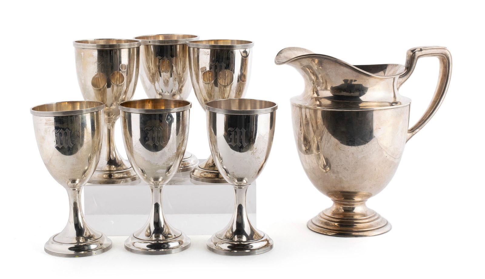 STERLING SILVER PITCHER AND SIX GOBLETS: STERLING SILVER PITCHER AND SIX GOBLETS20th century. Including a set of six (6) A.G. Schultz and Co. silver goblets, and a Frank Smith Silver Co. helmet form pitcher, all marked and monogrammed.1845 t