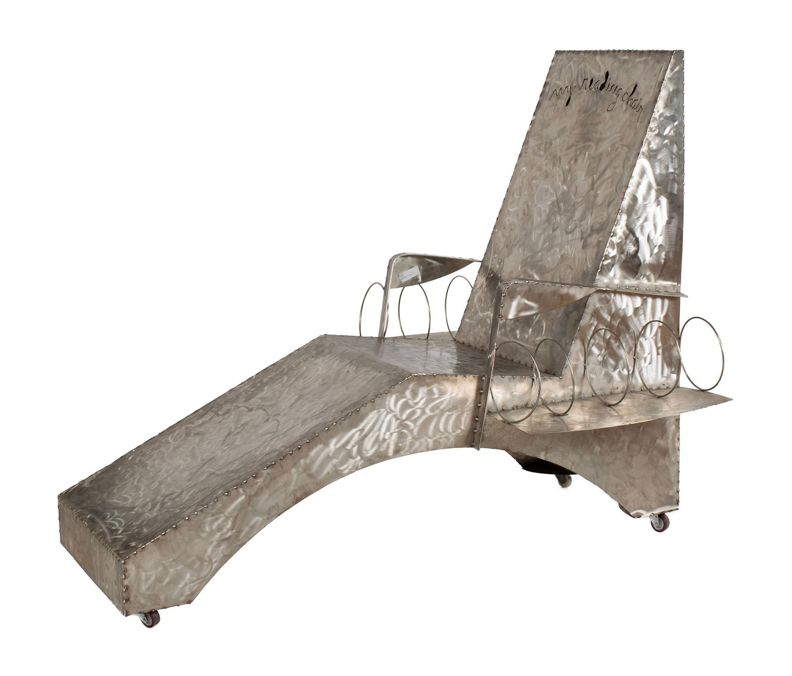 BROTHER MEL MEYER (AMERICAN (ST. LOUIS), 1928-2013): Brother Mel MeyerAmerican (St. Louis), 1928-2013My Reading ChairSteelWelded steel chaise lounge chair on wheels, with coil form book storage beneath arm rests and behind backrest.Brother Mel Me