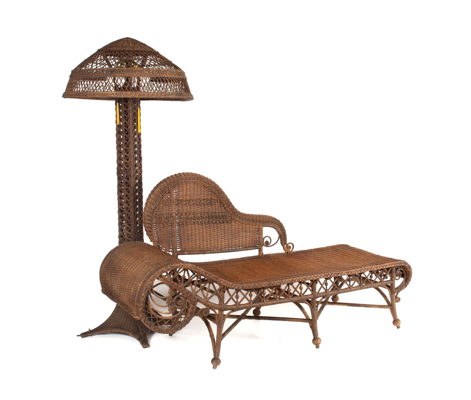 WICKER PARLOR SET: WICKER PARLOR SETAmerican, 20th century. Including a chaise lounge and floor lamp.Lamp: 70 x 29 in. (177.8 x 73.7 cm.), Chaise: 39 x 24 x 73 in. (99.1 x 61 x 185.4 cm.)