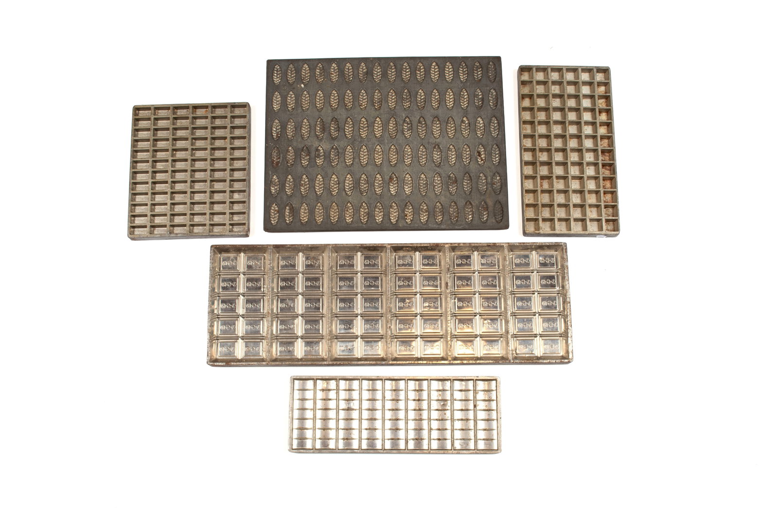 COLLECTION OF CHOCOLATE MOLDS: COLLECTION OF CHOCOLATE MOLDS Five (5) total: the largest showing a somewhat cursive "W S C" repetitively in the mold, another showing "Dutch Mill" repetitively in the mold and oth