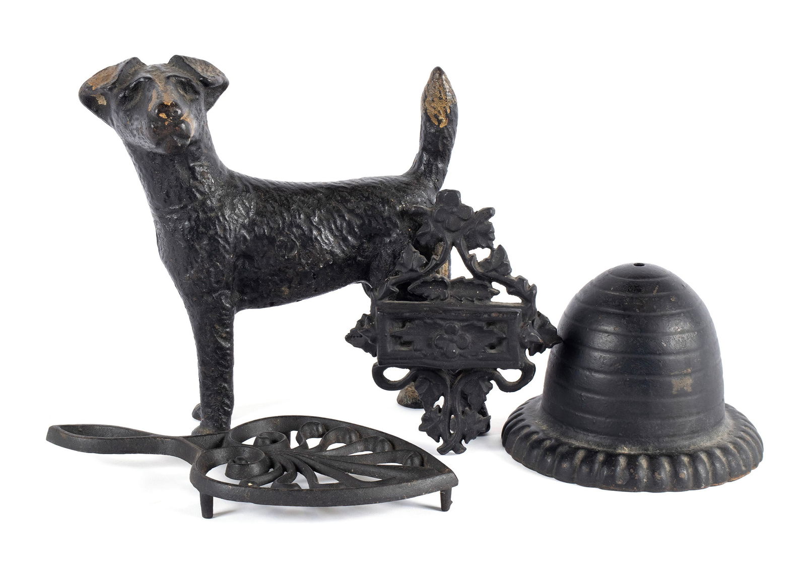 COLLECTION OF CAST IRON: COLLECTION OF CAST IRONAmerican, early 20th century. Four (4) total: dog form doorstop, iron trivet, wall mounted match holder and a string dispenser.Largest: 8 1/2 x 7 in. (21.6 x 17.8 cm.)