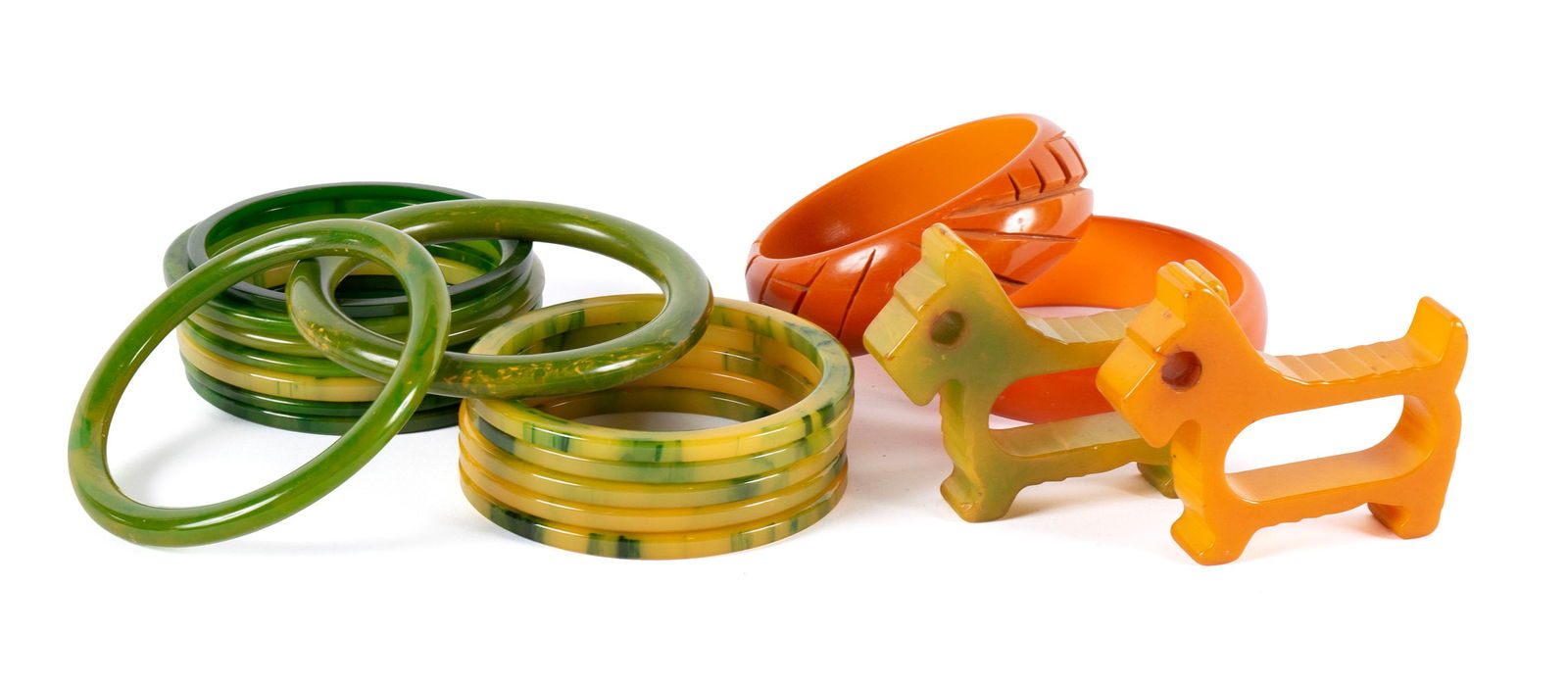 COLLECTION OF VINTAGE BAKELITE: COLLECTION OF VINTAGE BAKELITEEighteen (18) pieces: two wide tangerine bangles, six marbled yellow bangles, eight variations of green, and two scotty dog form napkin holders.Dog: 2 1/2 x 2 3/4 in. (6.