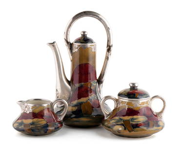 MOORCROFT 'CLAREMONT' STERLING OVERLAY COFFEE SET: MOORCROFT 'CLAREMONT' STERLING OVERLAY COFFEE SETEnglish, 1914. Three-piece coffee set with toadstool decoration, signed 'W. Moorcroft' and dated in green script, with Shreve & Co. stamps to silver.La
