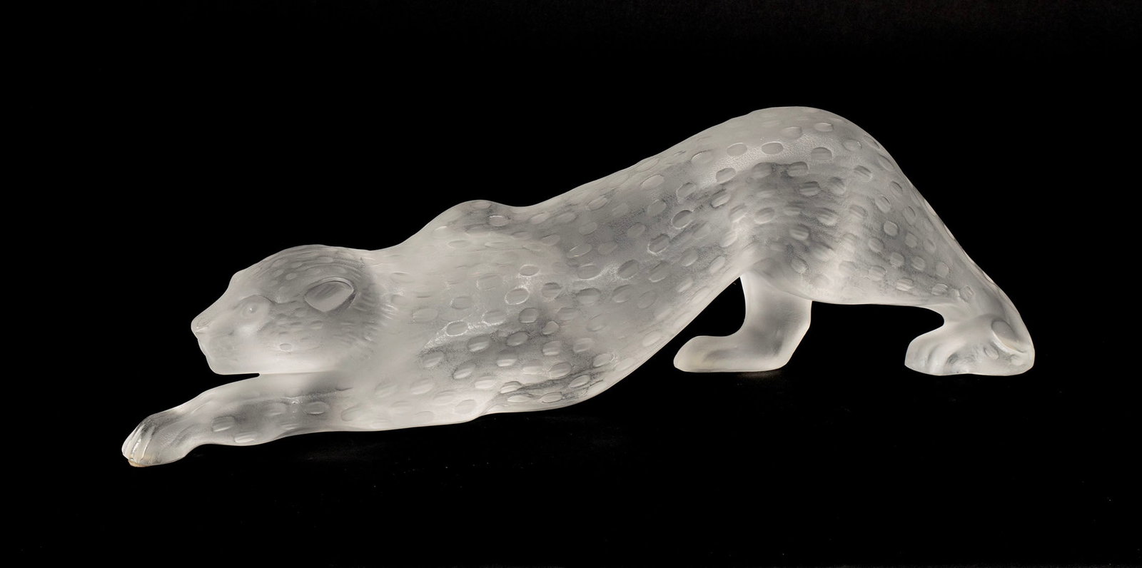LALIQUE CRYSTAL JAGUAR: LALIQUE CRYSTAL JAGUAR French, 20th century. Frosted crystal crouching jaguar figure, incised mark and sticker to underside. 4 1/4 x 14 1/2 in. (10.8 x 36.8 cm.)