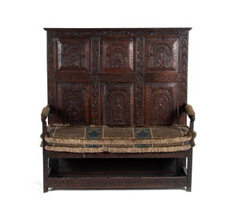 17TH CENTURY ENGLISH CARVED OAK SETTLE: ENGLISH CARVED OAK SETTLEEnglish,dated 1673, oak. Straight rectangular full back panels extend to the floor, the front with six figural carved panels, over the simple carved armrests and panel seat, a