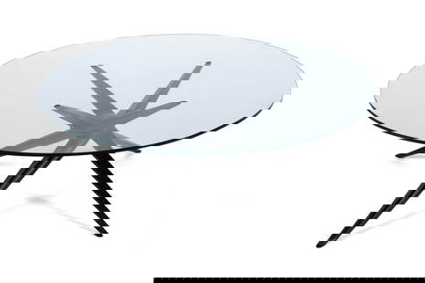DENNETT & BARKER COFFEE TABLE: DENNETT & BARKER COFFEE TABLEAmerican, designed by Guy Barker circa 1950, paper label to underside. Circular glass top on the ebonized maple base.15 1/4 x 40 in. (38.7 x 101.6 cm.) This table was show