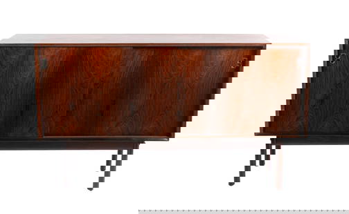ARNE VODDER FOR SIBAST MOBLER CREDENZA ON STAND: ARNE VODDER FOR SIBAST MOBLER CREDENZA ON STANDDanish, 1967, rosewood. Sliding doors cover the shelved interior.33 1/2 x 59 x 18 1/2 in. (85.1 x 149.9 x 47 cm.) Provenance: From the Florida residence