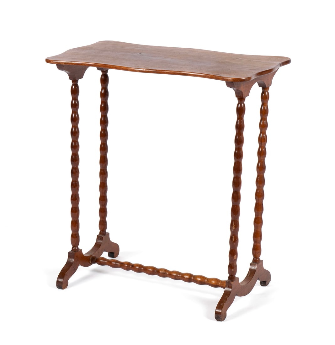 VICTORIAN SIDE TABLE: VICTORIAN SIDE TABLEAmerican, 19th century. Shaped top on delicate bobbin-turned legs with end supports near the floor connected by a stretcher.26 1/2 x 25 x 13 1/2 in. (67.3 x 63.5 x 34.3 cm.)