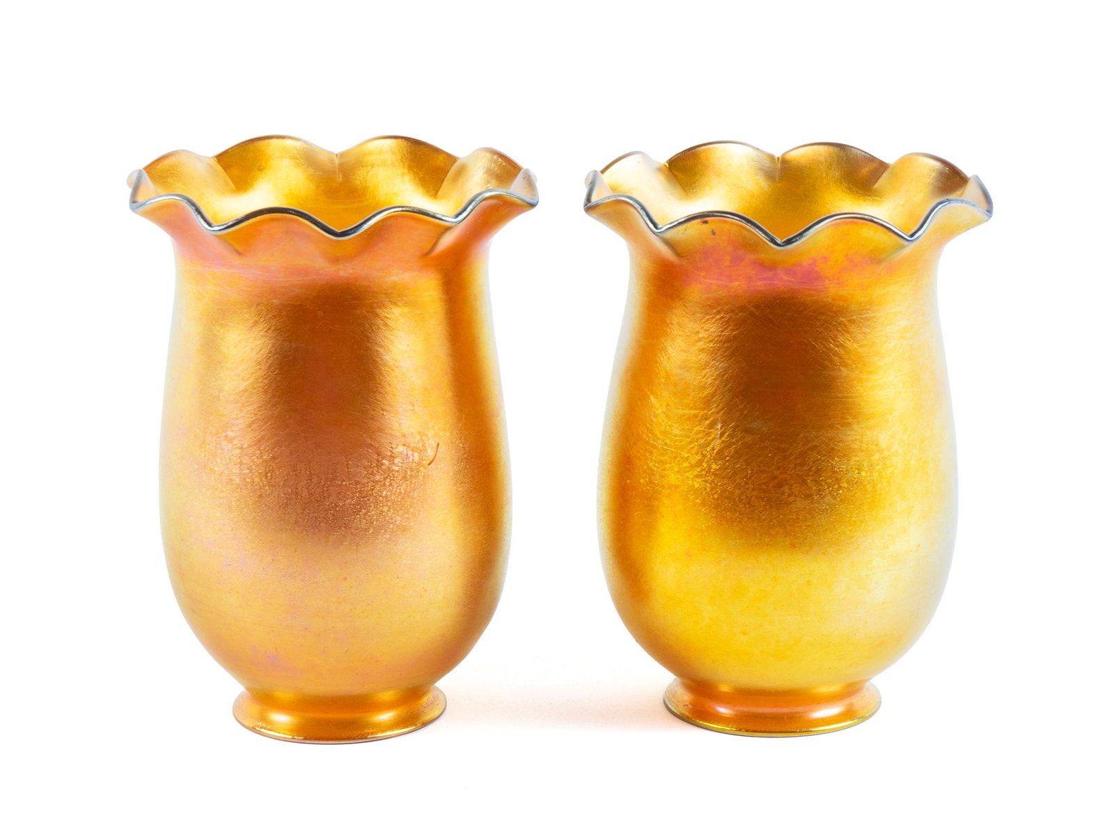 PAIR OF ART GLASS SHADES: PAIR OF ART GLASS SHADES20th century. Pair of bell form gold aurene art glass shades in the manner of Steuben, unsigned.5 3/4 x 4 in. (14.6 x 10.2 cm.)