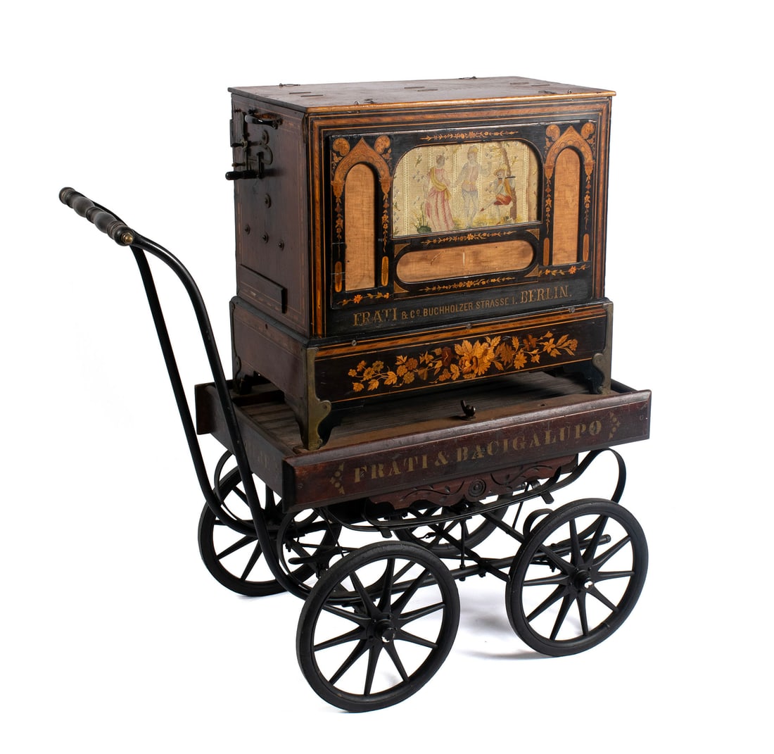 FRATI 37-KEY TRUMPET ORGAN ON WAGON: FRATI 37-KEY TRUMPET ORGAN ON WAGONGerman, 19th century. The 37-key crank mechanism features flutes, violins, and most likely clarinets. This barrel organ plays 8 songs with a hand crank to the back,
