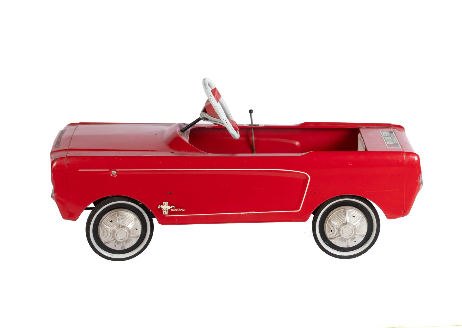 FORD MUSTANG PEDAL CAR WITH ADVERTISING: FORD MUSTANG PEDAL CAR WITH ADVERTISING American, 3rd-quarter 20th century. Red, with advertisement to the back for "ROSELLE FORD - ROSELLE, ILL.", stick shift still good. 18 x 16 x 39 in. (45.7 x 40.