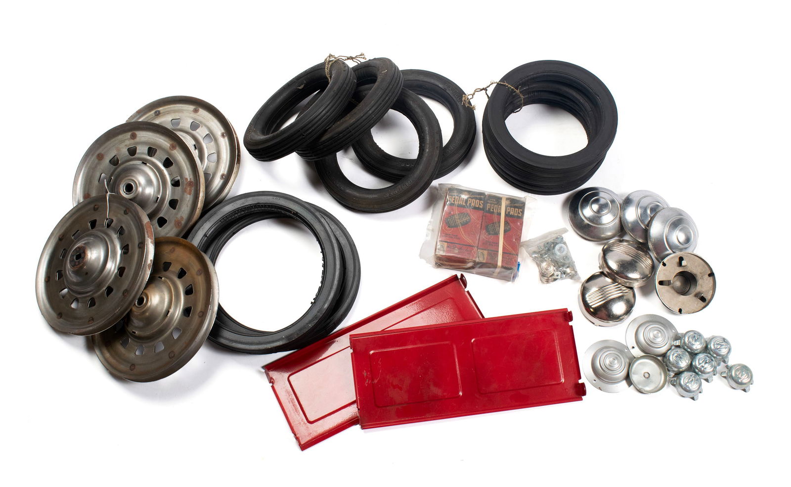 COLLECTION OF PEDAL CAR PARTS AND ACCESSORIES WITH TWO DUMP CARTS: COLLECTION OF PEDAL CAR PARTS AND ACCESSORIES WITH TWO DUMP CARTSCollection of pedal car parts & accessories, including ten (10) tires, four (4) wheels, seven (7) pair of hubcaps and one (1) miscellan