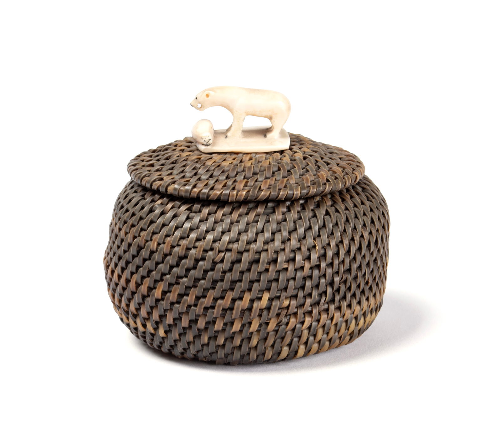 HUBERT KOONUK (KOONOOK) (INUIT (POINT HOPE, AK), 1911-1994): Hubert Koonuk (Koonook)Inuit (Point Hope, AK), 1911-1994Bone and baleenInitialed H.K. beneath the finial. Woven baleen basket, the lid with bone finial showing a bear over a seal.3.6 x 4 x 4 in. (9.1