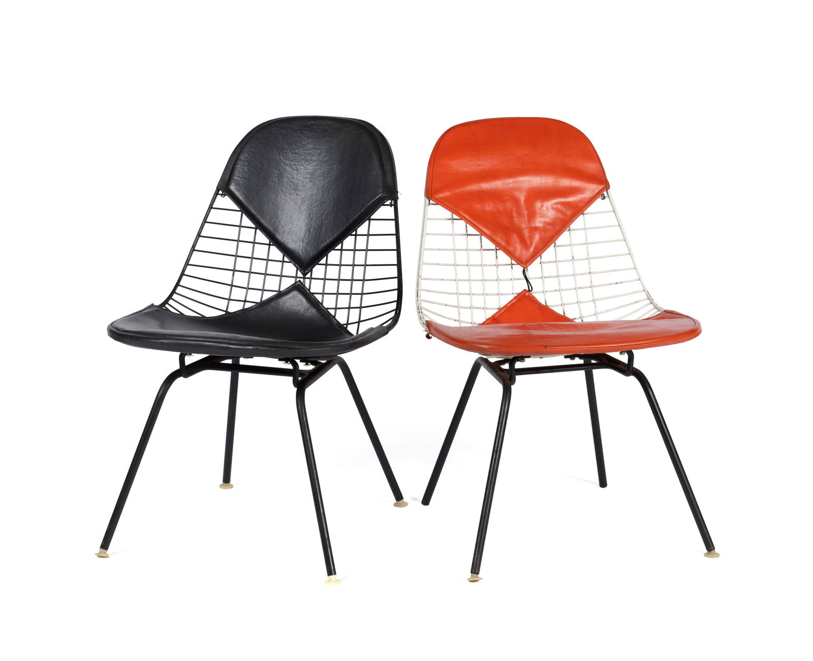TWO CHARLES & RAY EAMES FOR HERMAN MILLER 'BIKINI' CHAIRS: TWO CHARLES & RAY EAMES FOR HERMAN MILLER 'BIKINI' CHAIRSAmerican, circa 1957. One (1) black and one (1) orange, leather upholstered with black lacquered steel wire frames. Label to underside.Each: 29