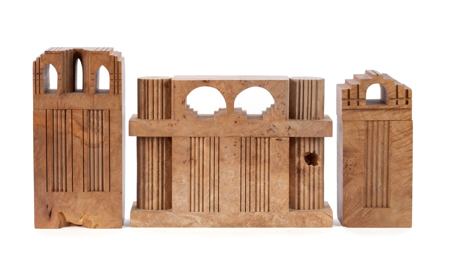 MICHAEL ELKAN (AMERICAN, 1942-2014): Michael ElkanAmerican, 1942-2014Oregon maple burlThree (3) architectural boxes, Pillar to Post Castle, and two Castles. Each stamped on underside.Largest: 10 x 3 x 5 in. (25.4 x 7.6 x 12.7 cm.)
