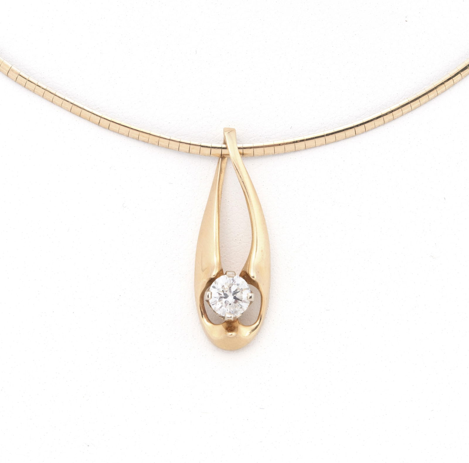 GOLD DIAMOND PENDANT NECKLACE: GOLD DIAMOND PENDANT NECKLACE A 14k yellow gold pendant set with one (1) round brilliant cut diamond weighing approximately 0.65ct (5.5mm x 3.45mm; Depth 62.7%; Color G; Clarity SI). Pendant is