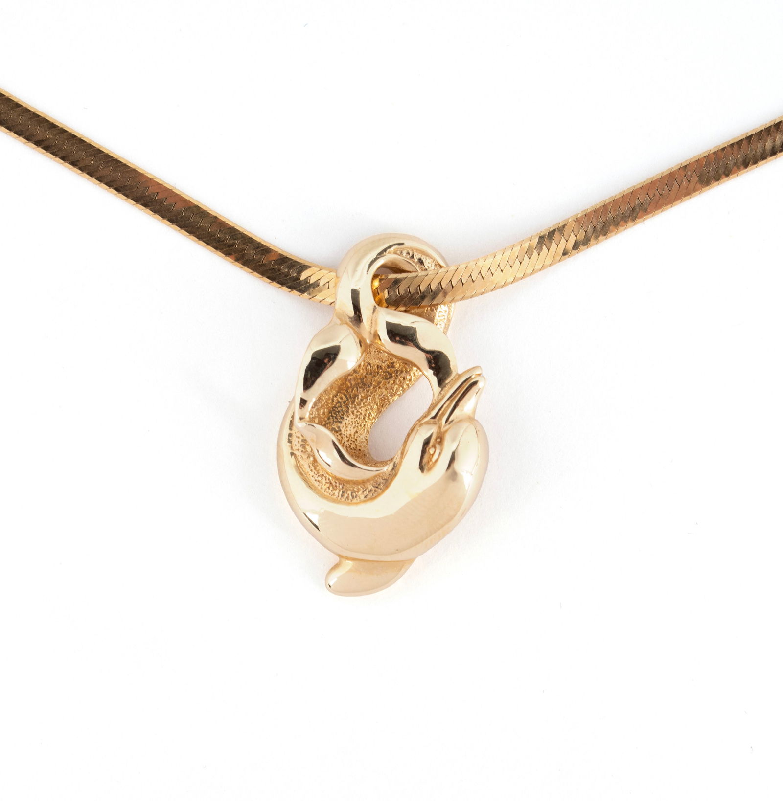 YELLOW GOLD DOLPHIN PENDANT NECKLACE: YELLOW GOLD DOLPHIN PENDANT NECKLACE A 14k yellow gold herringbone necklace with 14k yellow gold dolphin pendant. Hallmarks to both. Length: 16 in. (40.6 cm.); 15.5 grams